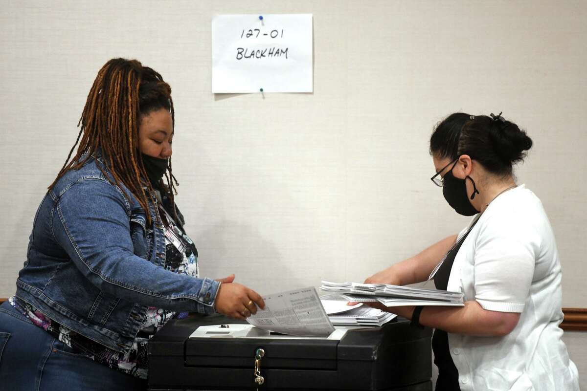 Election moderators recount ballots from last week’s state House 127th District primary, in Bridgeport, Conn. Aug. 16, 2022. Last week’s results showed City Councilman Marcus Brown defeated incumbent state Rep. Jack Hennessy by five votes.