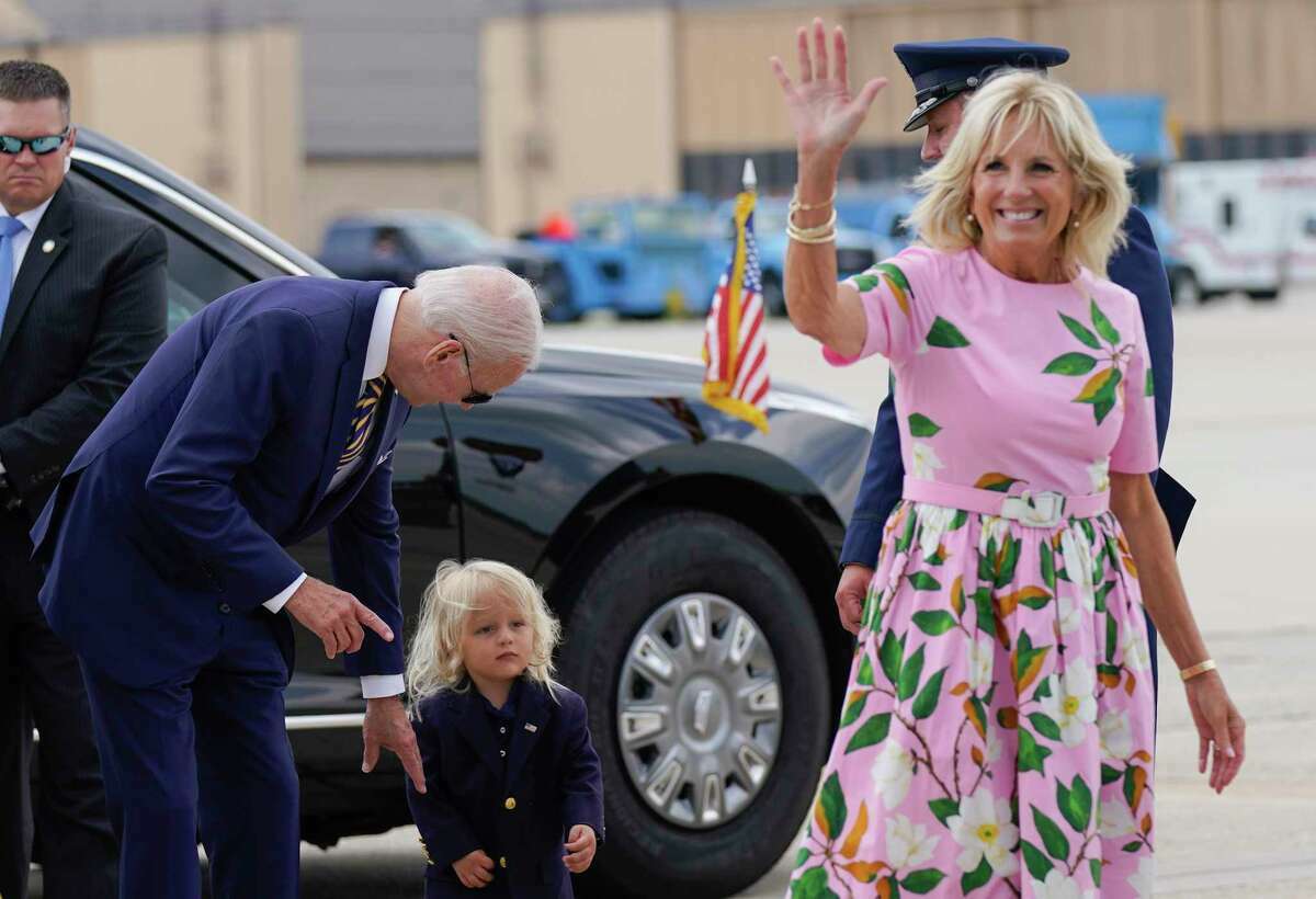 FILE - President Joe Biden looks at his grandson Beau Biden as first lady Jill Biden waves and walks to board Air Force One at Andrews Air Force Base, Md., Aug. 10, 2022. First lady Jill Biden tested positive for COVID-19 and is experiencing ‘mild symptoms’ the White House announced Tuesday.