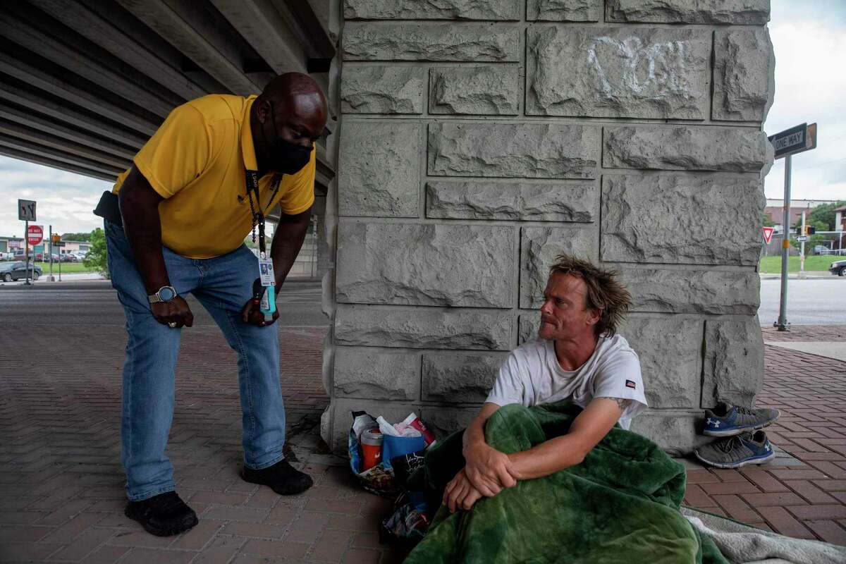 Trevor Baker, a clinical homeless outreach worker with the city’s Department of Human Services talks with Josh Palumbo who has been sleeping under Wurzbach Parkway. Trevor let Josh know he was in an extremely unsafe place and he should move somewhere else for his own safety.