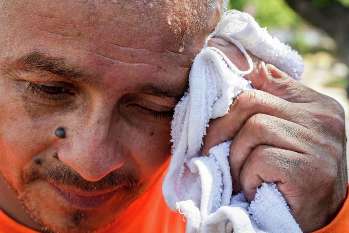 Javier Martinez wipes sweat from his face after laying shingles on a roof as temperatures reach over 100 degree today in downtown Vacaville, Calif. on Tuesday, Aug. 16, 2022. Afternoon temperatures reached triple digits in parts of the Bay Area, prompting a heat advisory from the National Weather Service.
