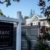 A home is seen with a For Sale sign posted outside the front gates in Atherton, Calif. Thursday, July 25, 2019.