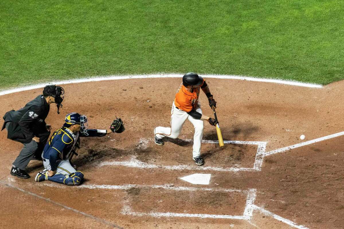 San Francisco Giants' Austin Slater bunts the ball during the fourth inning of a MLB baseball game against the Milwaukee Brewers in San Francisco, Calif. Friday, July 15, 2022.