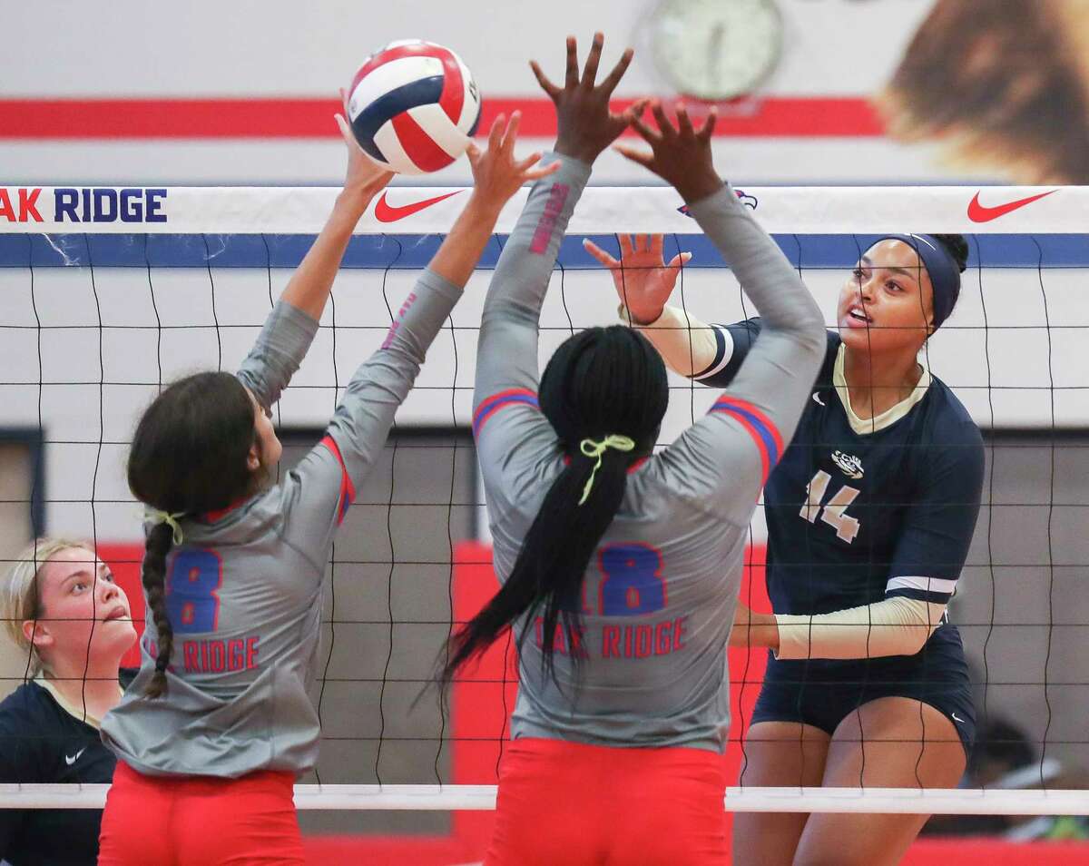 Klein Collins' Ariana Goode (14) gets a shot past Oak Ridge's Gaby Santiago (8) and Luvina Oguntimehin (18) in the first set of a non-district high school volleyball match at Oak Ridge High School, Tuesday, Aug. 16, 2022, in Oak Ridge North.