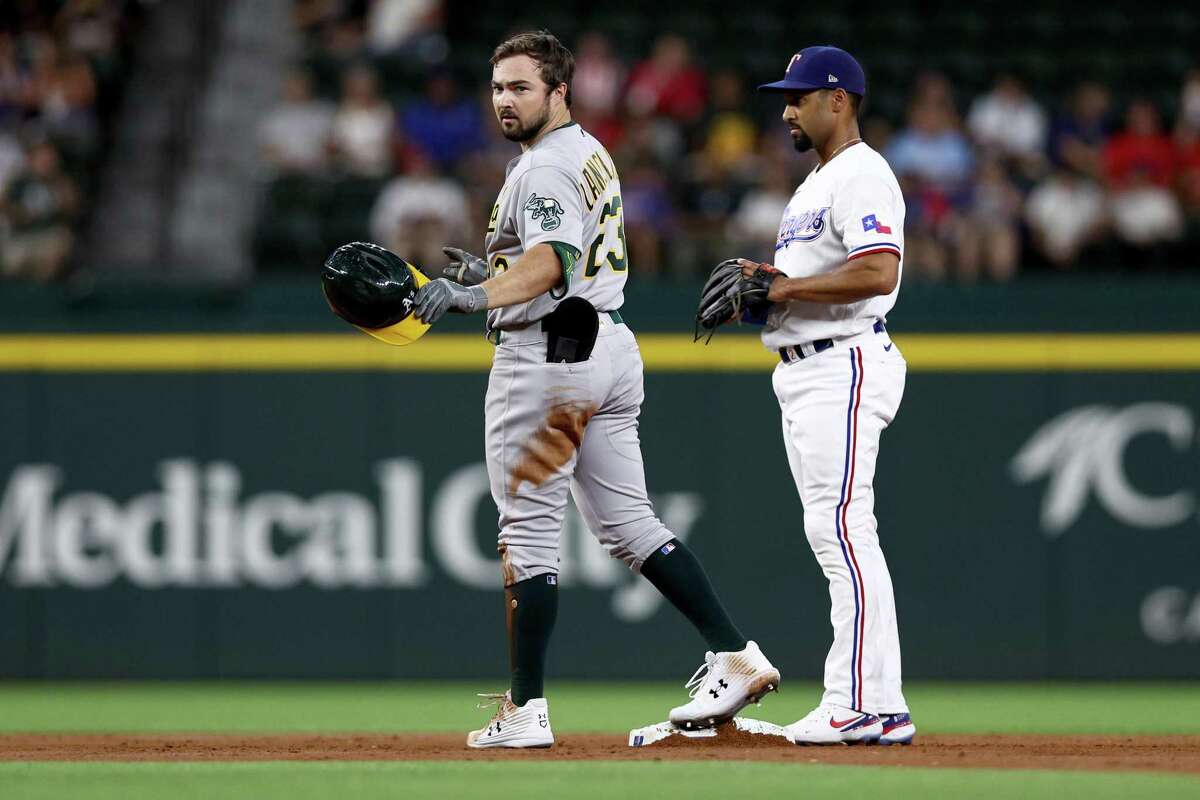ARLINGTON, TEXAS - AUGUST 16: Shea Langeliers #23 of the Oakland Athletics reacts after getting his first Major League hit off of Kohei Arihara #35 of the Texas Rangers in the top of the \\2i at Globe Life Field on August 16, 2022 in Arlington, Texas. (Photo by Tom Pennington/Getty Images)