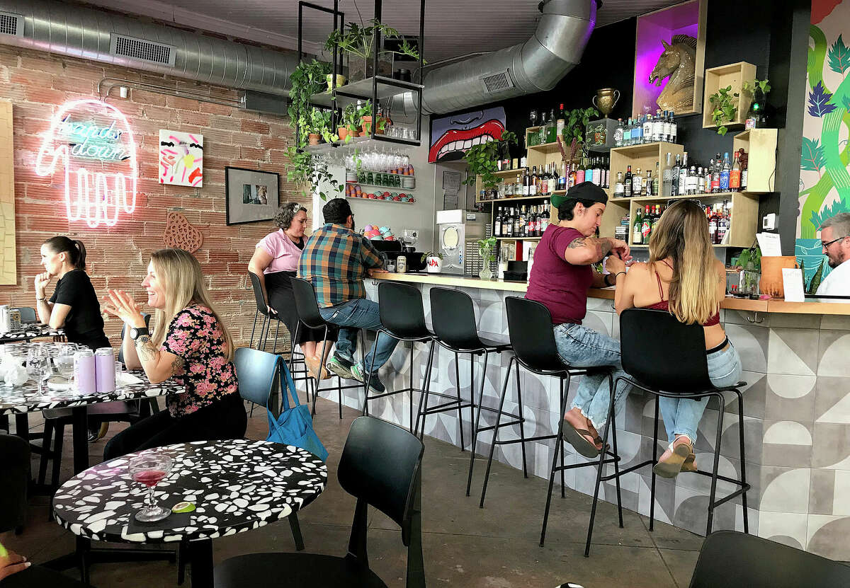 Patrons enjoy a round of drinks during happy hour at Hands Down in San Antonio's Lavaca neighborhood.
