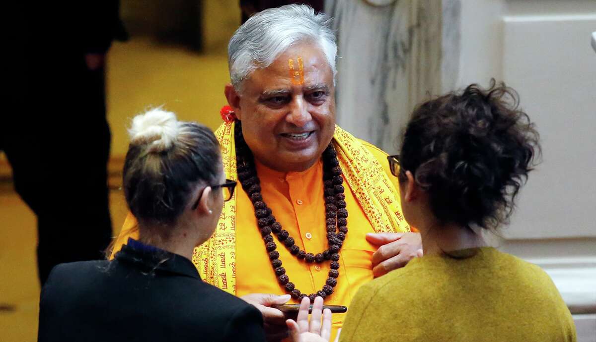 Universal Society of Hinduism President Rajan Zed, center, talks with Oklahoma Senate staffers before delivering a prayer to start the day in the Senate in Oklahoma City, on April 30, 2018.