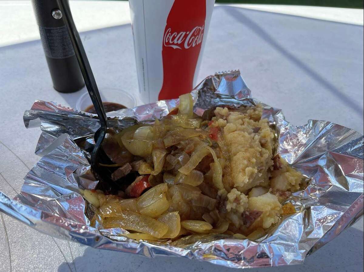 The steak tip dinner at the Midland County Fair is comprised of chopped steak topped with onions, peppers and mushrooms and potatoes on the side. des 