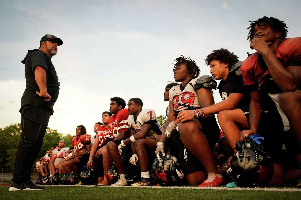 Westfield High School Mustangs Head Football Coach Matt Meekins talks with his varsity players at the end of practice Thursday, Aug. 11, 2022, at the school in Houston.