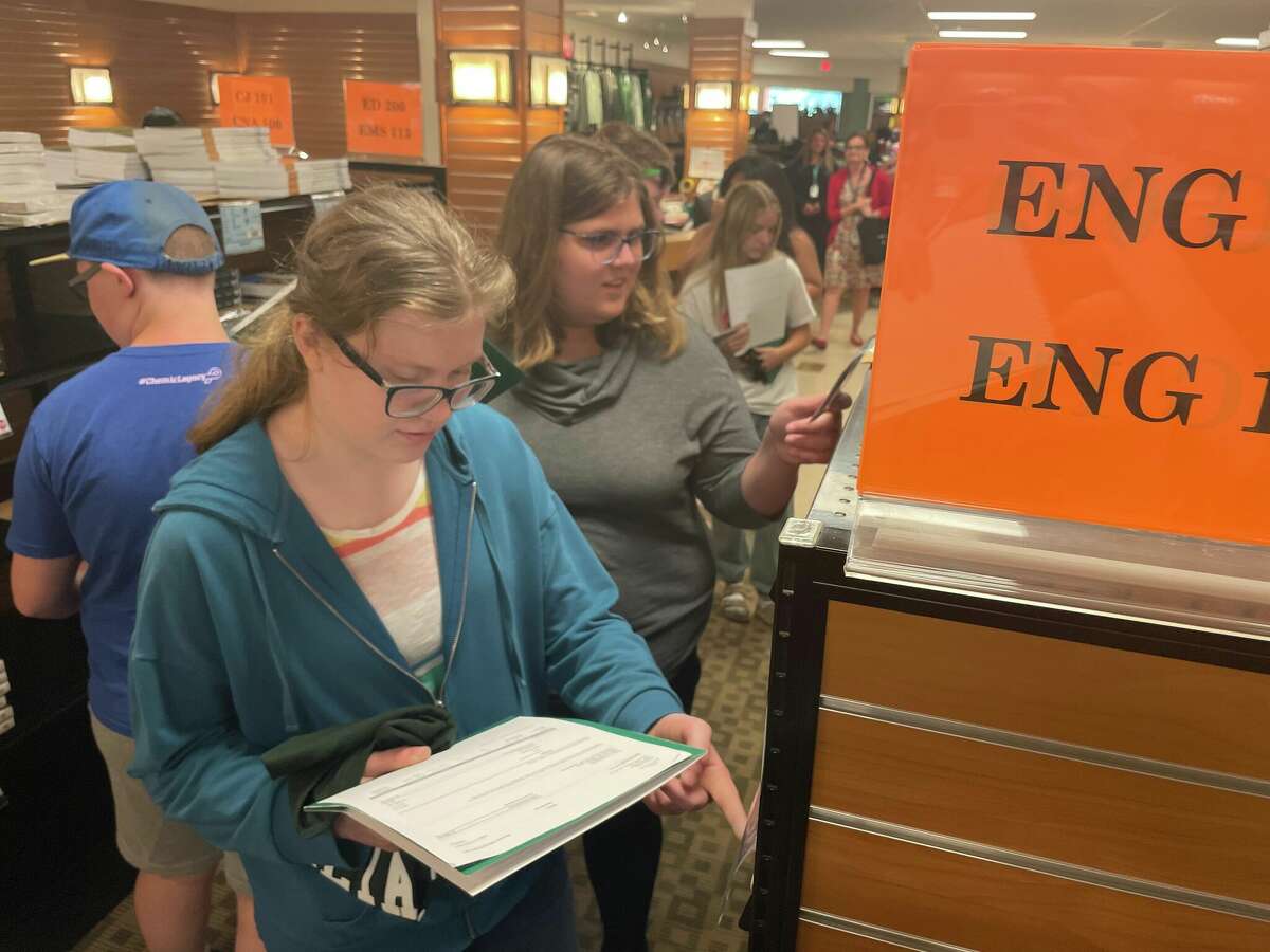 Midland High School rising juniors Katy Kraenzlein, left, and Emma Trudell, right, explore the Delta College bookstore for English textbooks on Wednesday, Aug. 17, 2022 as enrollees in the new Early Middle College Program at Midland Public Schools. 