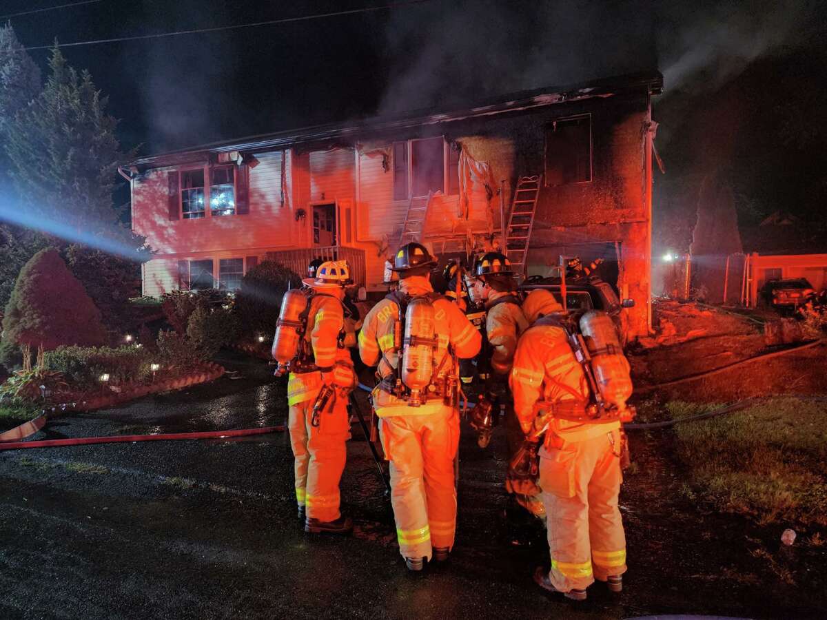 Firefighters from Brookfield helped to overhaul a home in New Milford that caught fire Tuesday, Aug.16, 2022. Officials said two people were displaced in the blaze, but no injuries were reported.