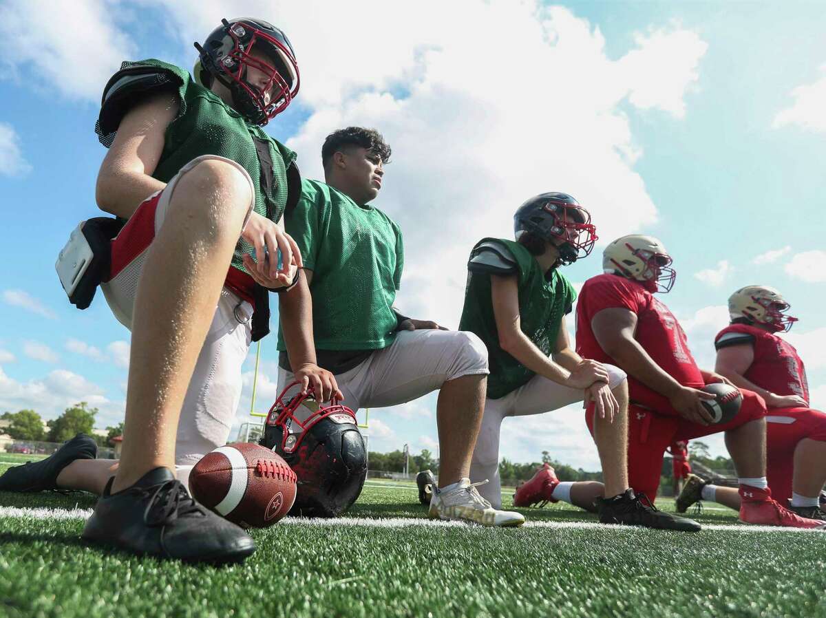 Caney Creek quarterback Christian Aguilar, center, watches a drill during a Caney Creek High School football practice, Saturday, Aug. 13, 2022, in Grangerland.
