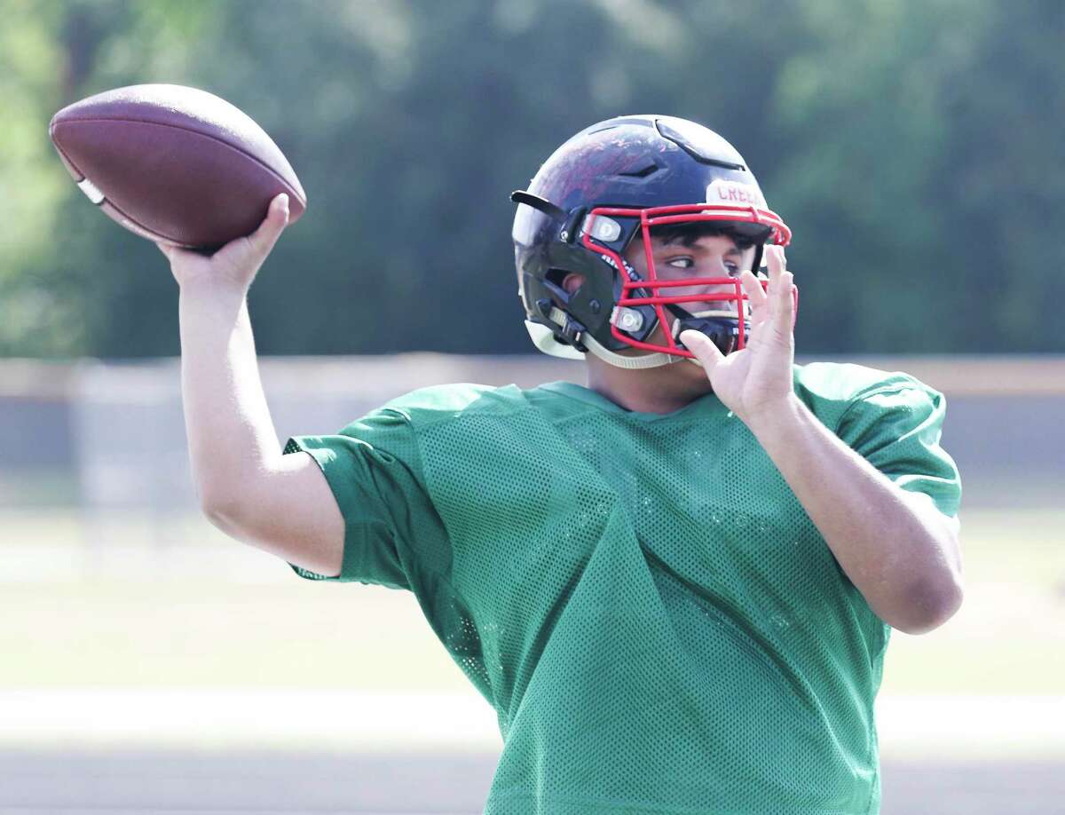 Caney Creek quarterback Christian Aguilar warms up during a Caney Creek High School football practice, Saturday, Aug. 13, 2022, in Grangerland.