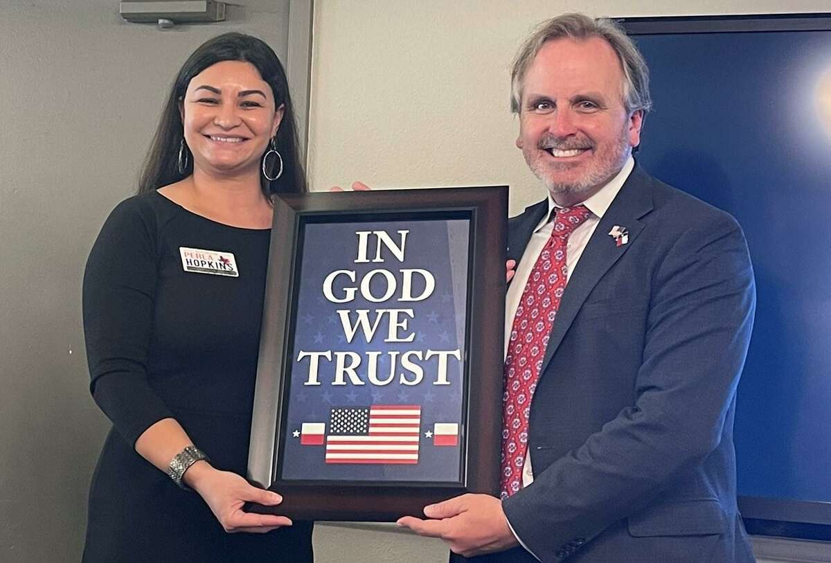 State Sen. Bryan Hughes, R-Mineola, and Perla Hopkins, a former teacher and Republican candidate for Texas House who supported Senate Bill 797, which requires school districts to post signs with the national motto, In God We Trust, in conspicuous places on campus, provided that the signs are donated.