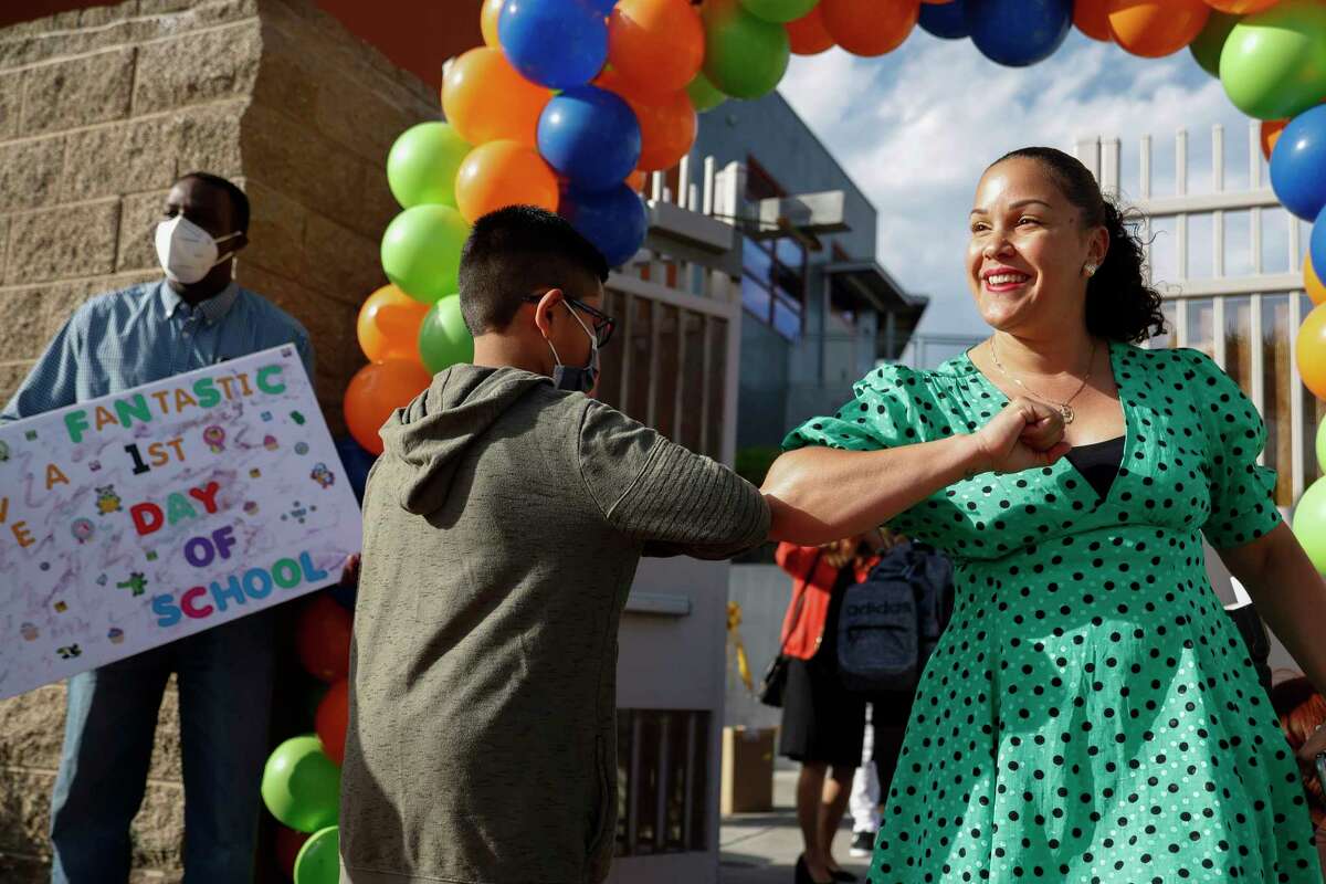 Willie Brown Jr. Middle School Principal Malea Mouton-Fuentes greets students as they walk the red carpet onto campus on their first day of school at Willie Brown Jr. Middle School in San Francisco, Calif. Wednesday, Aug. 17, 2022.