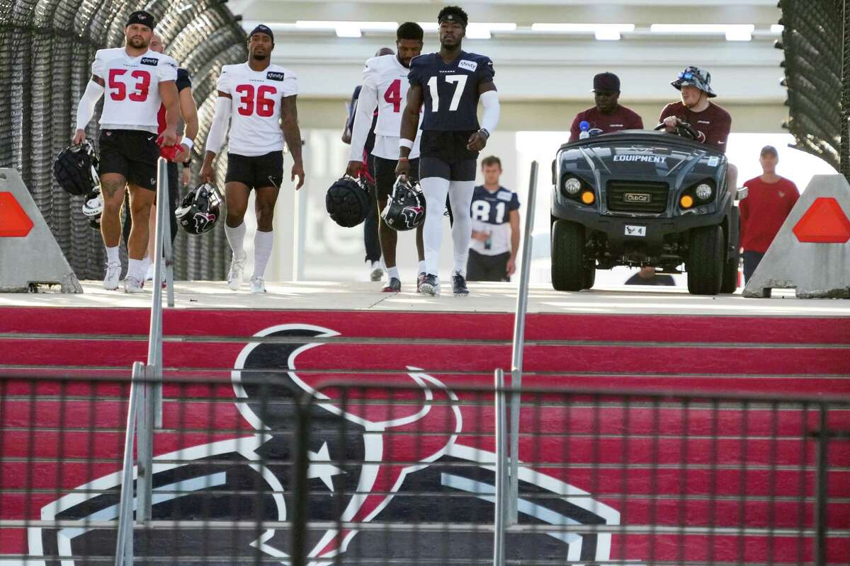 Houston Texans players walk across the Kirby bridge to the practice field during an NFL training camp Wednesday, Aug. 17, 2022, in Houston.