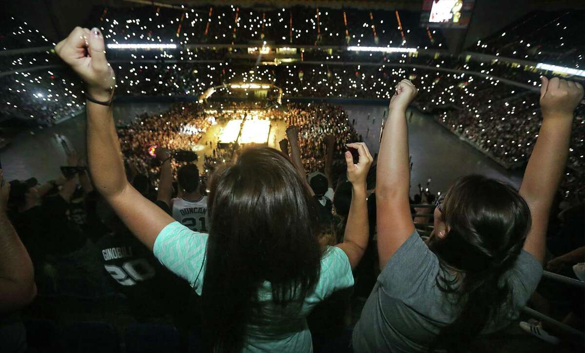 Spurs fans, an estimated 70,000, cheer on their feet as the San Antonio Spurs take the stage in the Alamodome during the Spurs celebration party Wednesday June 18, 2014.