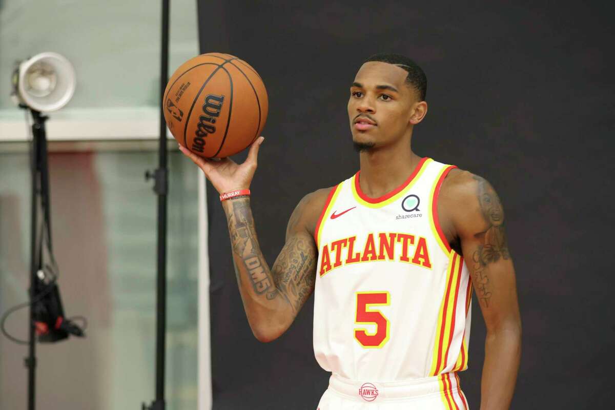 Atlanta Hawks guard Dejounte Murray poses for photographs following an NBA basketball press conference at the Emory Sports Medicine Complex, Friday, July 1, 2022, in Atlanta. (Jason Getz/Atlanta Journal-Constitution via AP)