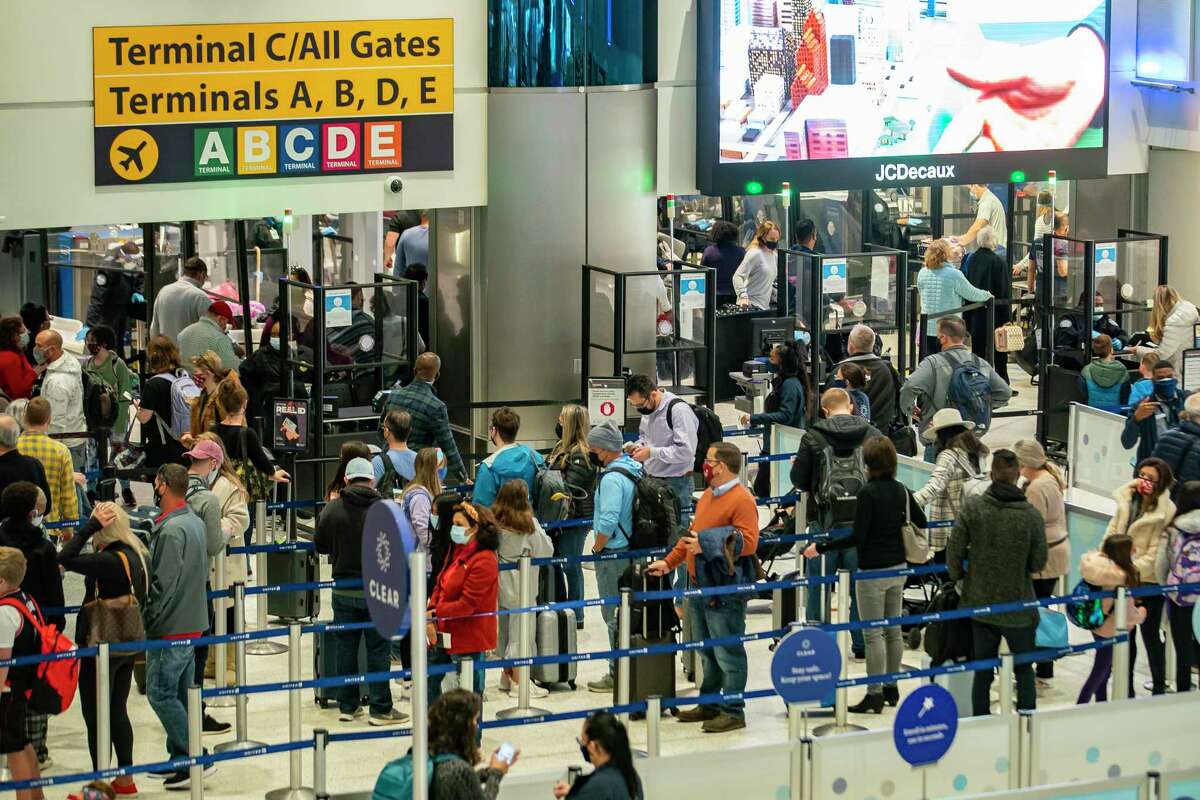 Travelers wait in line to get through security at Bush Intercontinental Airport in Houston. The airport system is expecting the busiest spring break season on record this year.