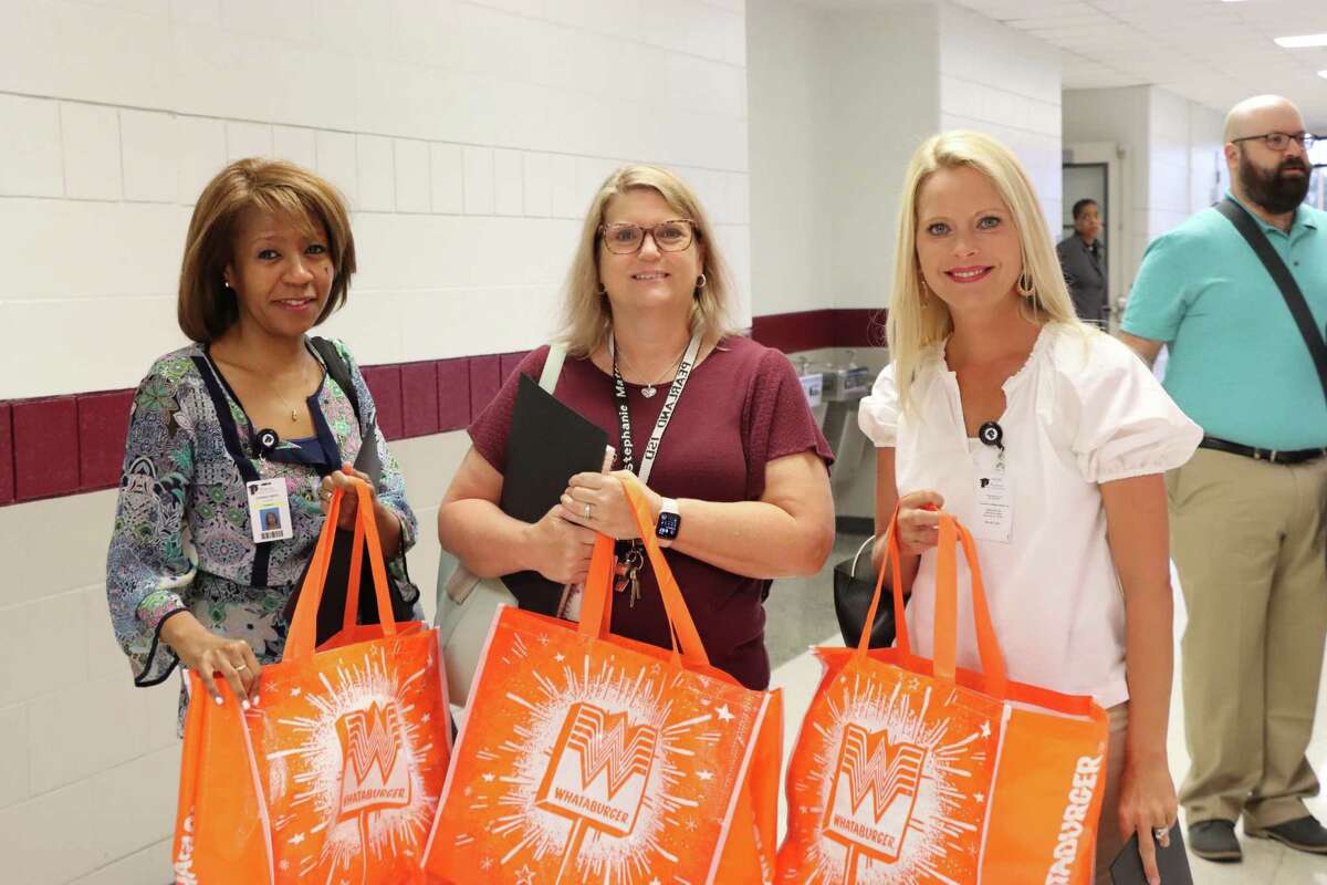 Teachers hold gift bags Aug. 2 at Pearland Independent School District’s annual orientation.