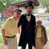 The Fosters pose with an Abraham Lincoln lookalike, Kevin Wood, at the Glen Carbon Heritage Museum on July 30. 