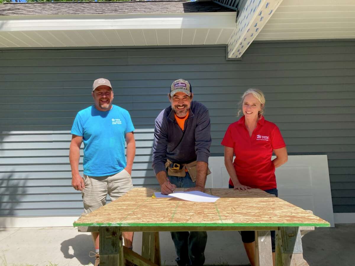  Habitat for Humanity Grand Traverse Region held a signing ceremony Aug. 11 in Kalkaska to formally kick off its new carpenter apprenticeship. Pictured from left is project manager, Curtis Cobb, Matt Powell, carpenter apprentice and Angela Skeans-Clem, director of operations for Habitat for Humanity Grand Traverse Region.