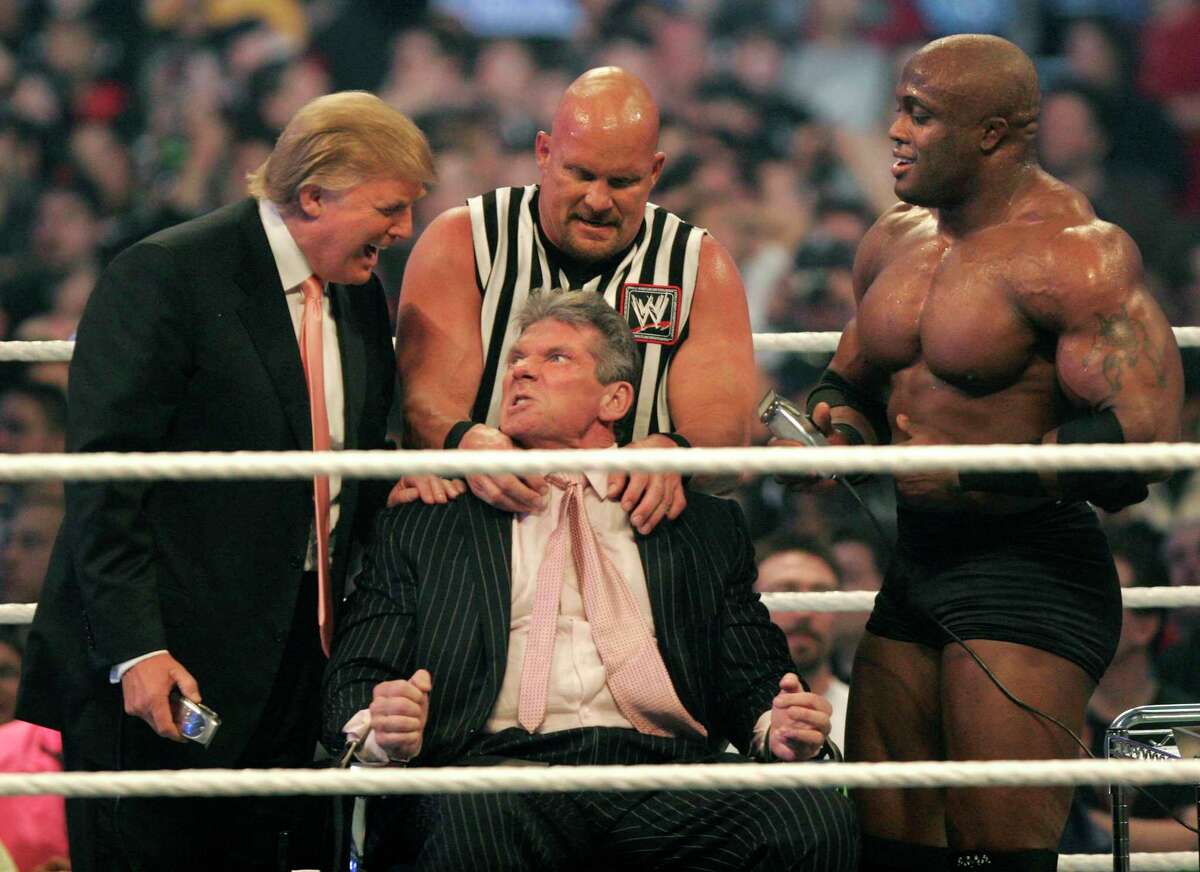 WWE chairman Vince McMahon, center, has his head shaved by Donald Trump, left, and Bobby Lashley, right, while being held down by ''Stone Cold'' Steve Austin after losing a bet in the Battle of the Billionaires at the 2007 World Wrestling Entertainment's Wrestlemania at Ford Field on April 1, 2007 in Detroit, Michigan. Umaga was representing McMahon in the match when he lost to Bobby Lashley who was representing Trump. (Photo by Bill Pugliano/Getty Images)