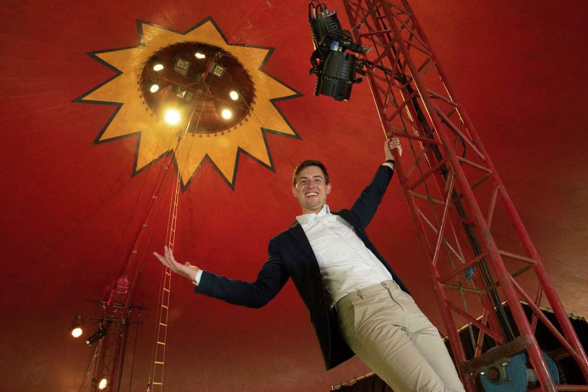 Aaron Marquise, executive director of Troy-based Contemporary Circus and Immersive Arts Center, hangs off a lighting pole in the circus tent at Prospect Park on Thursday, Aug. 18, 2022 in Troy, N.Y.