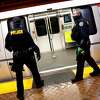 BART Police officer Eric Hofstein and Nathan Young in Powell Street station in San Francisco, Calif., on Monday, January 4, 2021.