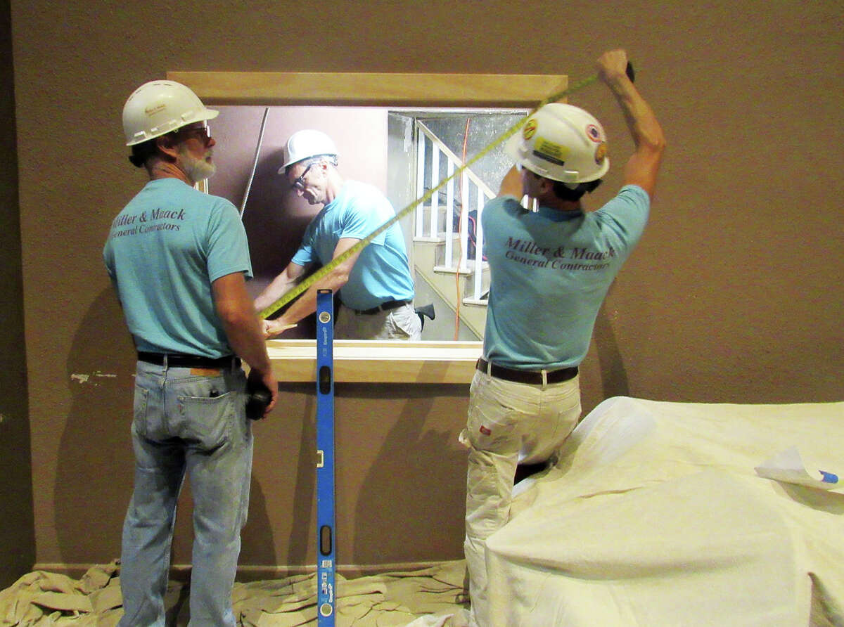 Workers from Miller & Maack General Contractors work on a space they opened on Thursday they opened near the stage at the Wildey Theatre, which will become the Opera Box History Exhibit.