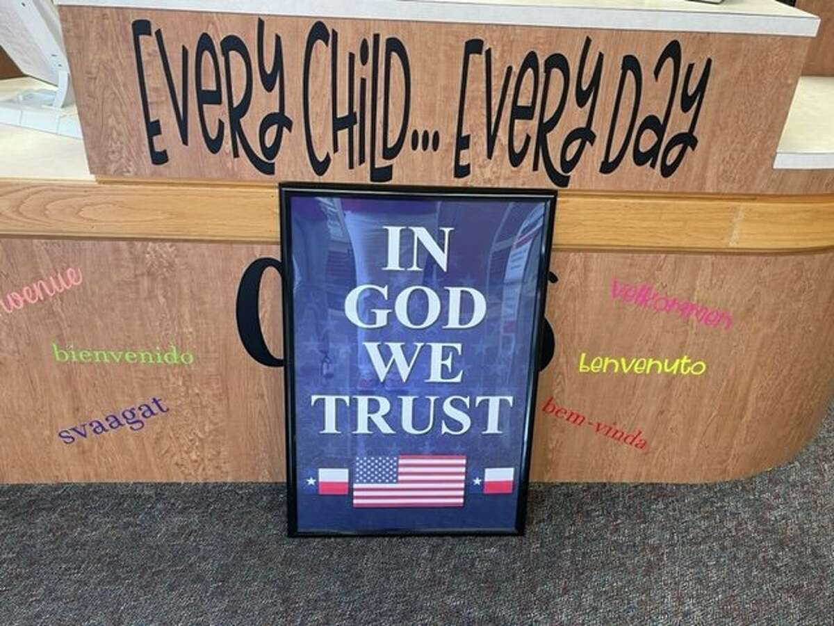 Texas public schools are required to hang up signs with the motto "In God We Trust" if they are donated to a school district under a new law. 