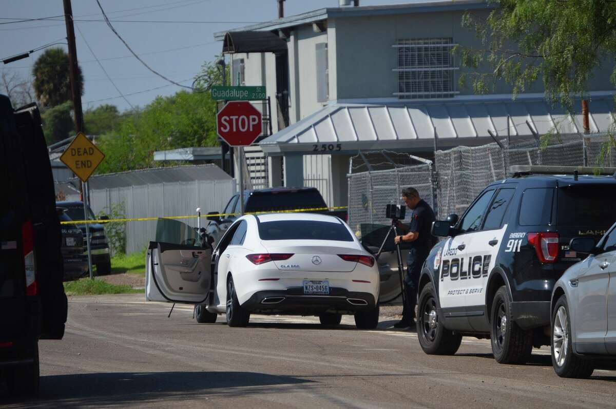 Authorities can be seen processing the area where a man was found fatally shot inside a white car by Guadalupe Street and North Texas Avenue on Thursday morning. Laredo police said this death marked the city's 10th homicide.