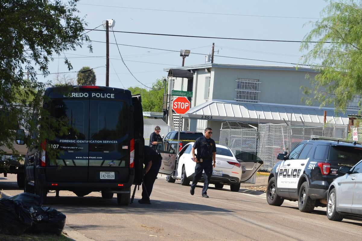 Authorities can be seen processing the area where a man was found fatally shot inside a white car by Guadalupe Street and North Texas Avenue on Thursday morning. Laredo police said this death marked the city's 10th homicide.