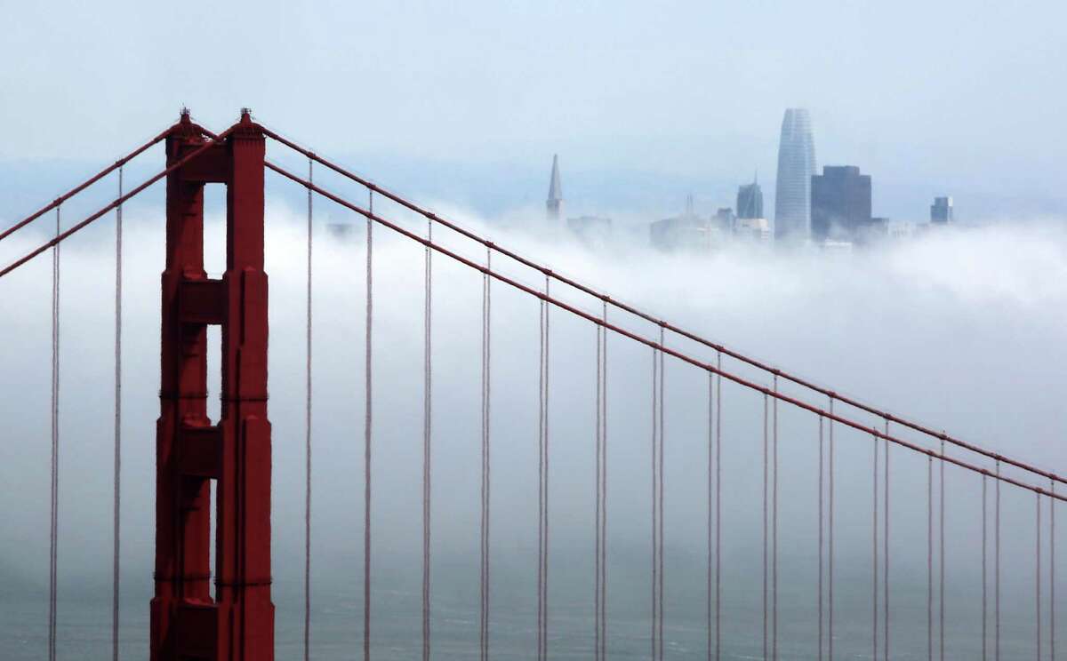 Heavy fog rolls past the Golden Gate Bridge and San Francisco skyline.