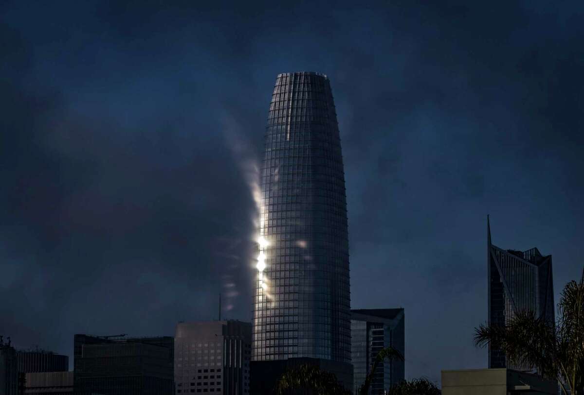 Salesforce Tower puts on a light show as the fog returns after a brief storm in San Francisco.