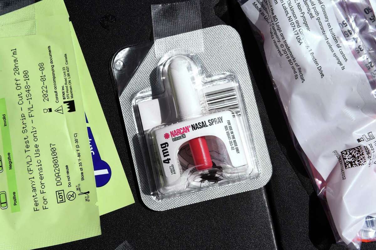 From left, fentanyl test strips, Narcan nasal spray and syringes of Naloxone were on display at a table where they were distributed by SWAN, Sex Workers and Allies Network, at an Overdose Awareness Day event held on the New Haven Green on August 31, 2021.