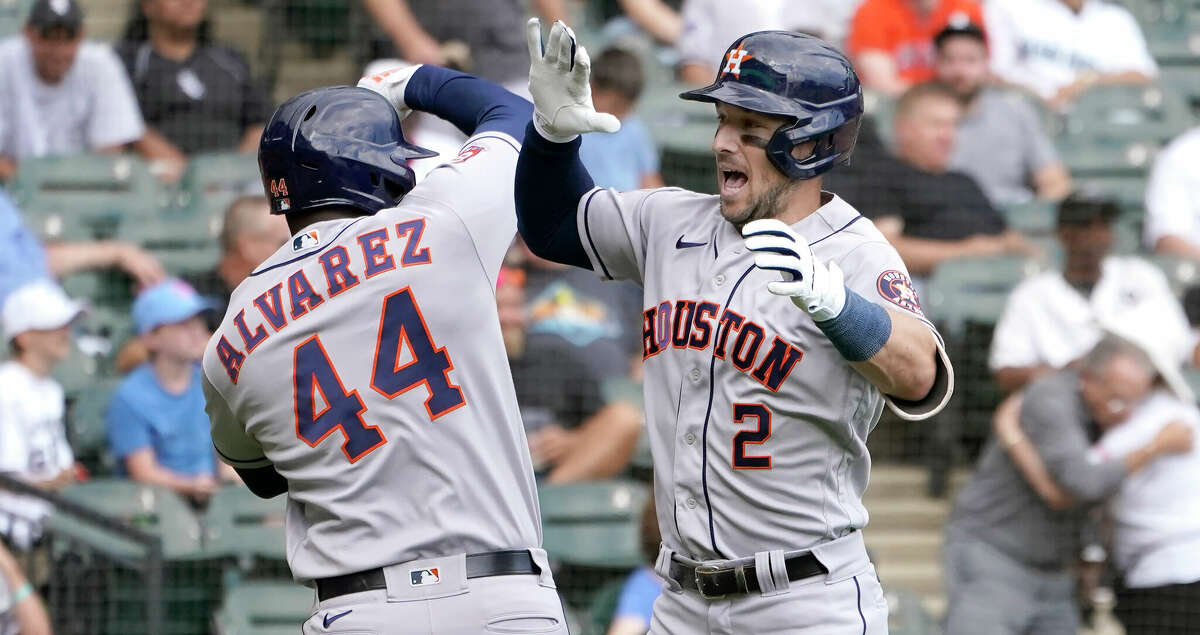 Houston Astros' Alex Bregman, right, celebrates with Yordan Alvarez after they scored on Bregman's two-run homer off Chicago White Sox relief pitcher Vince Velasquez during the fourth inning of a baseball game Thursday, Aug. 18, 2022, in Chicago. (AP Photo/Charles Rex Arbogast)