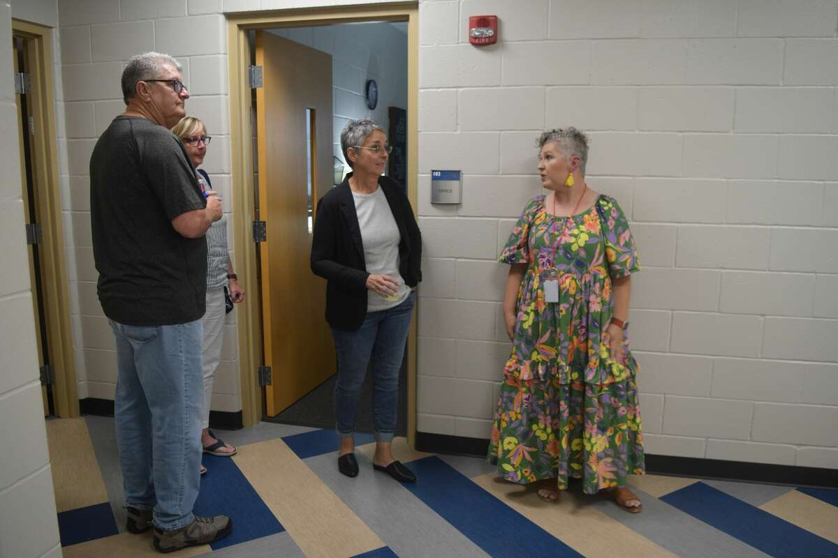 Meredith Vogel-Thomas, Morgan County Health Department office manager, guides guests through the department's new building during its open house event.