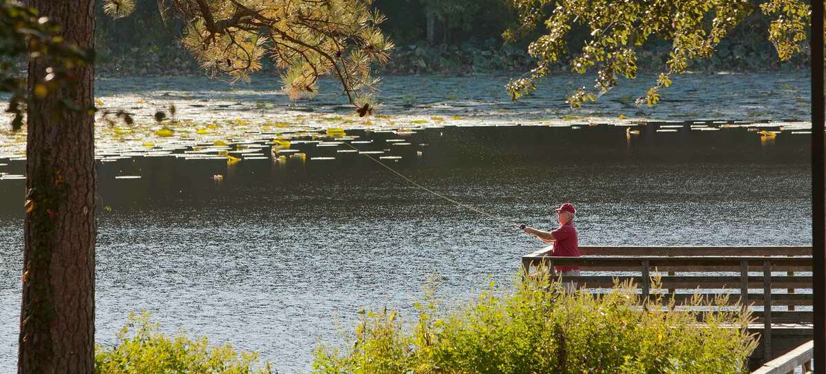 A man is seen fishing in Lake Raven at Huntsville State Park in Huntsville, Texas. The park is part of Sam Houston National Forest and is a great spot in East Texas to see the colors of autumn.