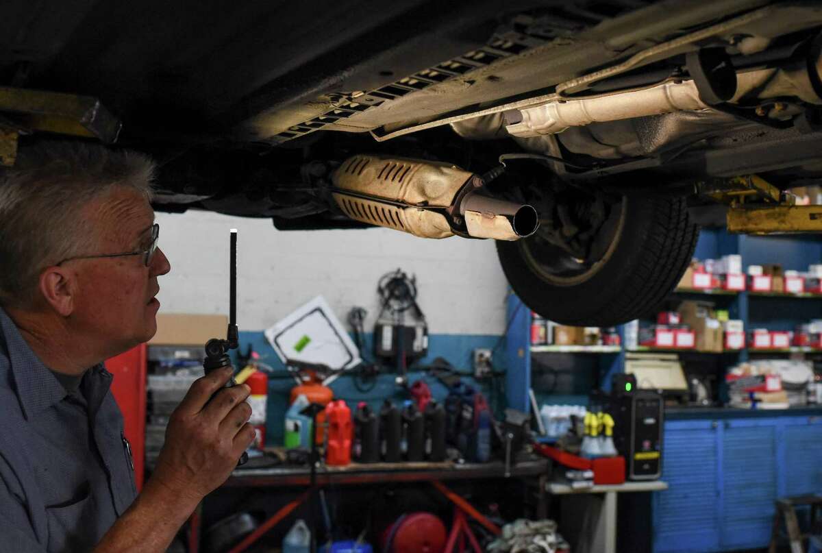 Todd Goulding, owner of Alouis Auto Repair, points out where a catalytic converter was cut off in a Honda Accord that was stolen in San Francisco.