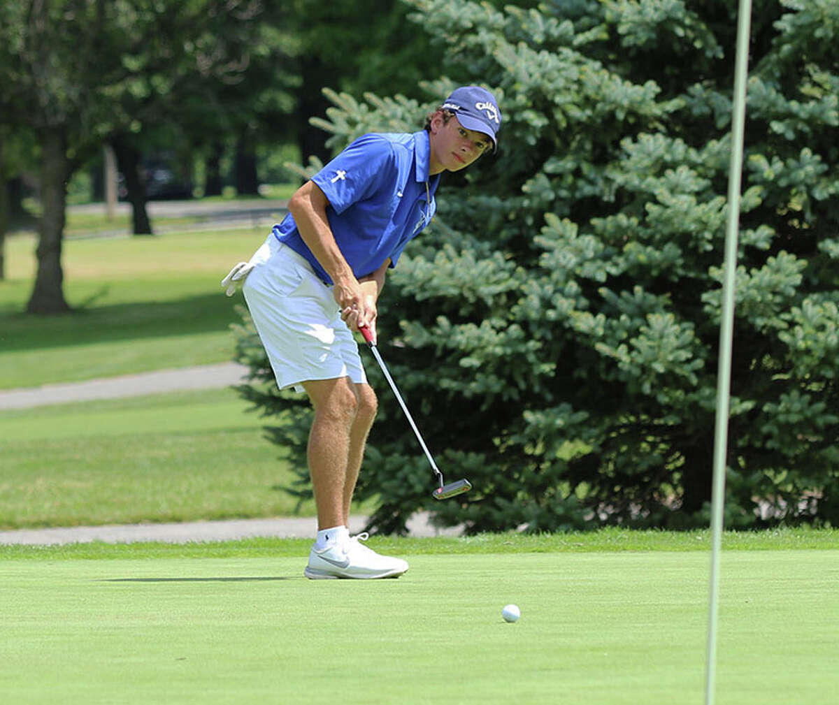 Marquette Catholic senior Will Schwartz watches his putt roll toward to the cup on hole No. 2 at Belk Park on Thursday in the Madison County Tournament in Wood River. Schwartz was small-schools runner-up with a 74.
