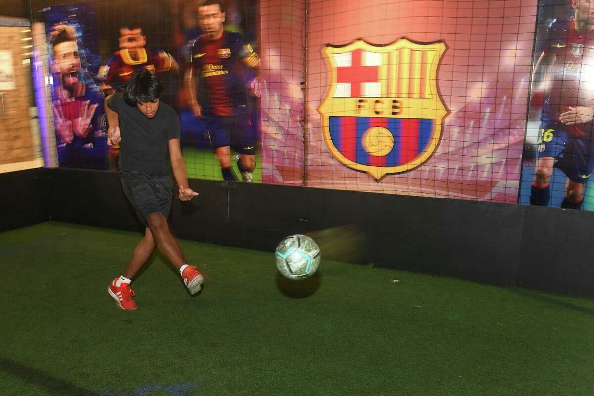 Romario Vasquez, of Stamford, practices at the new Soccer Fun Zone on the eighth level of Stamford Town Center mall, in downtown Stamford, Conn., on Aug. 15, 2022.