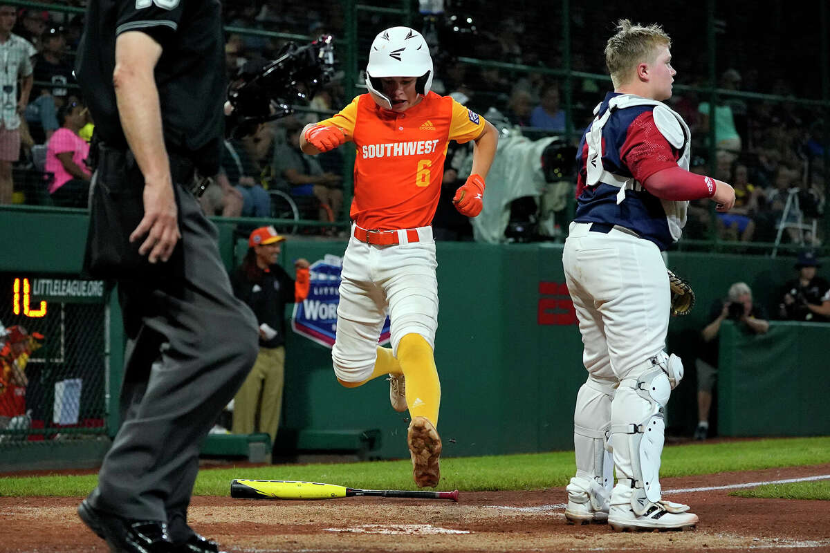 Pearland, Texas' Jacob Zurek (6) scores behind Hollidaysburg, Pa.'s Braden Hatch, right, during the fifth inning of a baseball game at the Little League World Series in South Williamsport, Pa., Thursday, Aug. 18, 2022. (AP Photo/Gene J. Puskar)
