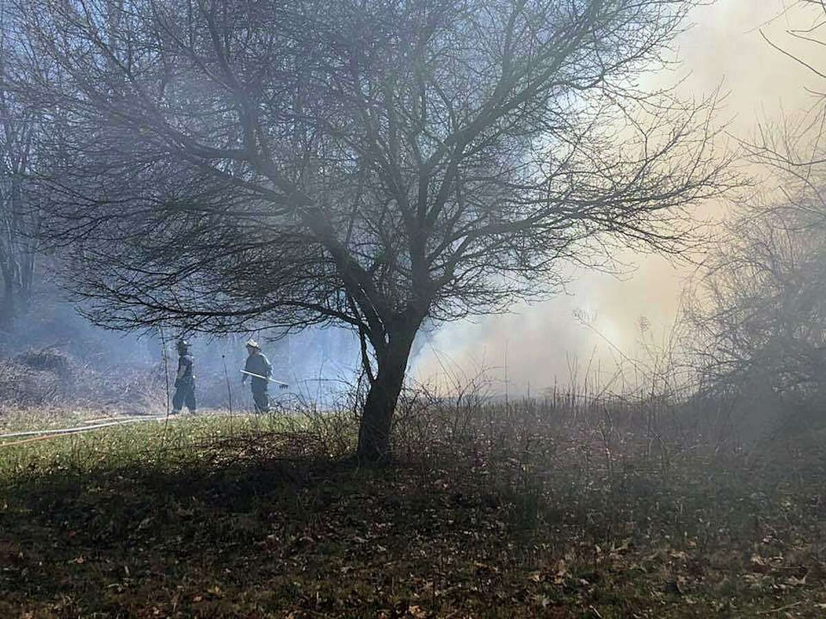 FILE PHOTO: Crews battle a brush fire in Osbornedale State Park in Derby, Conn., The risk of fire is very high or extreme throughout Connecticut on Friday, Aug. 19, 2022, as dry conditions and weeks of drought continue.