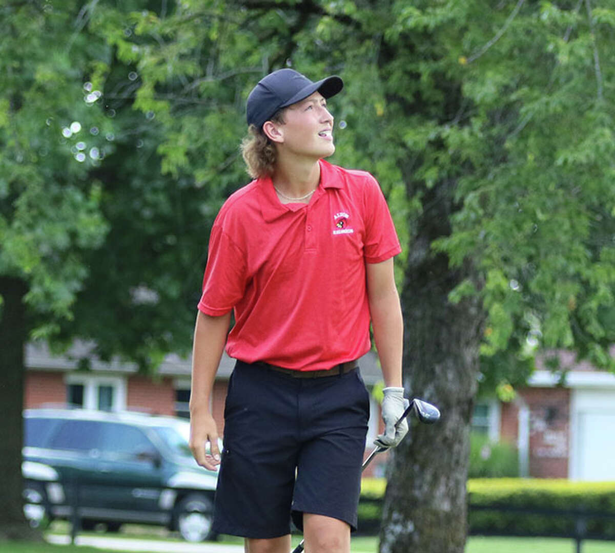 Alton junior Cooper Hagen watches his tee shot on hole No. 3 at Belk Park in Thursday's Madison County Tournament in Wood River. Hagen shot 85 in the tourney.