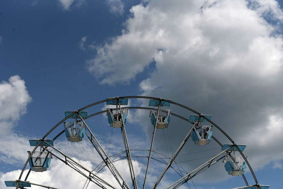 Fair goers enjoy a Ferris Wheel ride at the Altamont Fair on Friday, Aug. 19, 2022, in Altamont, N.Y.