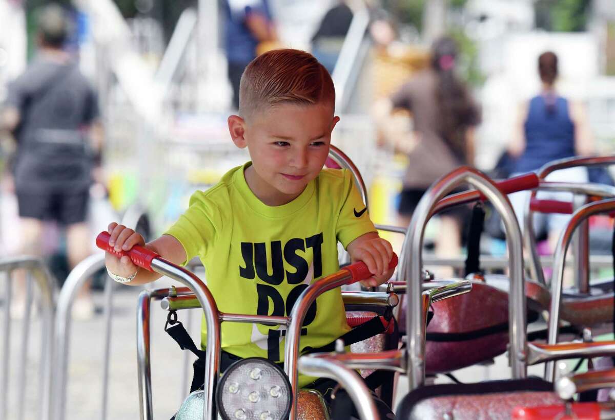 Camden Amsler, 4, of Voorheesville is thrilled with his amusement ride at the Altamont Fair on Friday, Aug. 19, 2022, in Altamont, N.Y.