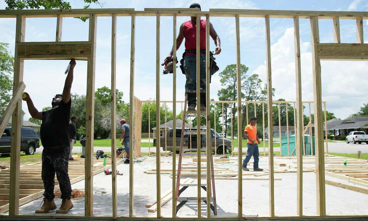 Crews work on a new home sponsored by HUD on Friday, Aug. 12, 2022 in Port Arthur. Five years after Harvey struck, some community in Port Arthur are still feeling the impact.