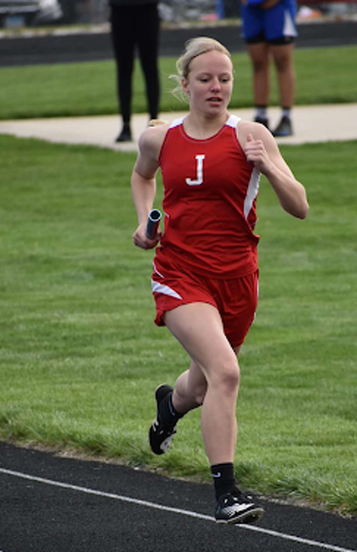 Jacksonville Middle School's Elizabeth Saxer competes in a relay at the IESA State Track Meet in Peoria.