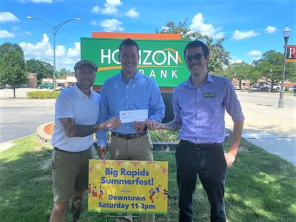 Chad Nastoff (center) and Logan Faught (left) with Horizon Bank presented a check for $7,500 to Chris Jane (right) the Big Rapids Downtown Business Association in support of its community efforts throughout the summer months. 