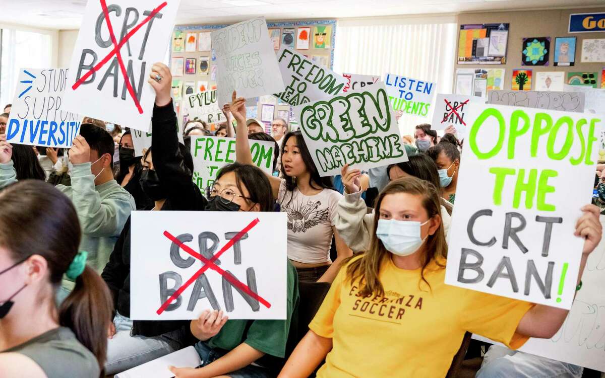PLACENTIA, CA - MARCH 23: Students against the CRT ban make their views known while pro-ban speakers talk during the public comment portion of a meeting of the Placentia-Yorba Linda Unified School Board in Placentia on Wednesday, March 23, 2022 to consider banning the academic concept of critical race theory in the district. Some parents worry that language in a proposed CRT resolution could lead to the loss of Advanced Placement classes. (Photo by Leonard Ortiz/MediaNews Group/Orange County Register via Getty Images)